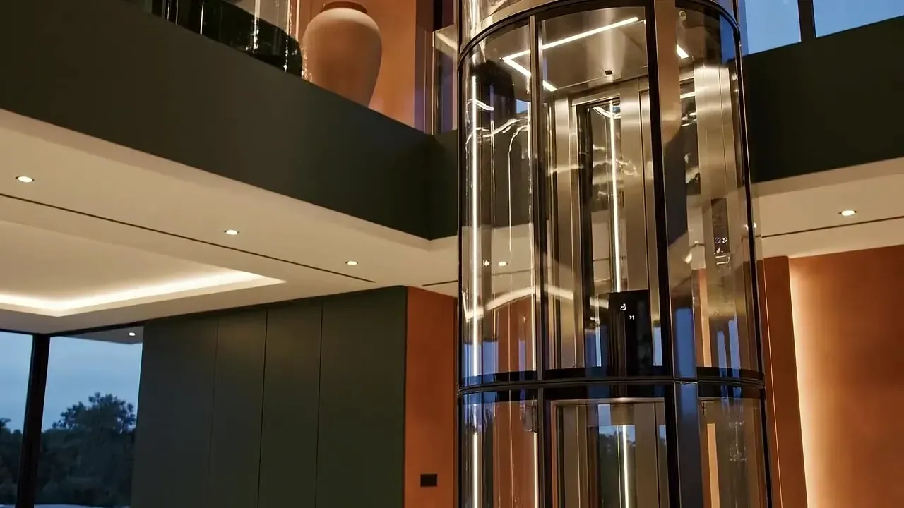 Glass home elevator rising between two floors of a house